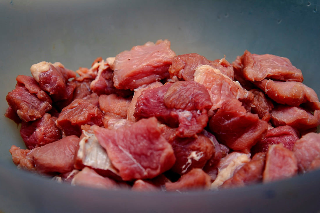 Chunks of raw meat in a bowl, ready to portion