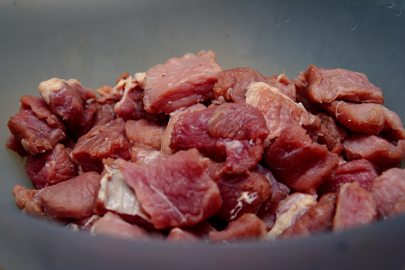 Chunks of raw meat in a bowl, ready to portion